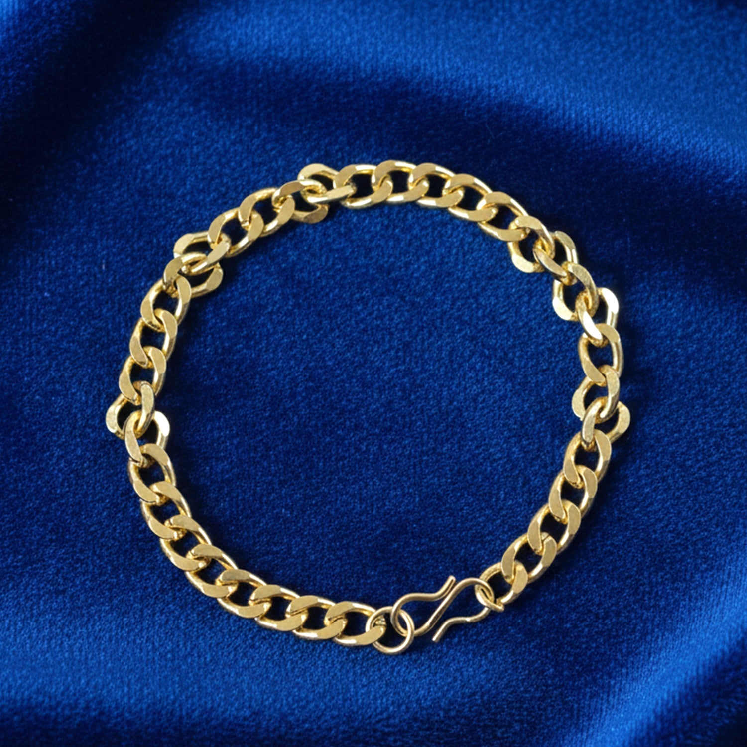 Polished gold tone chain link bracelet with secure clasp