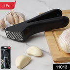 Close-up of manual garlic press crusher tool showing ergonomic design