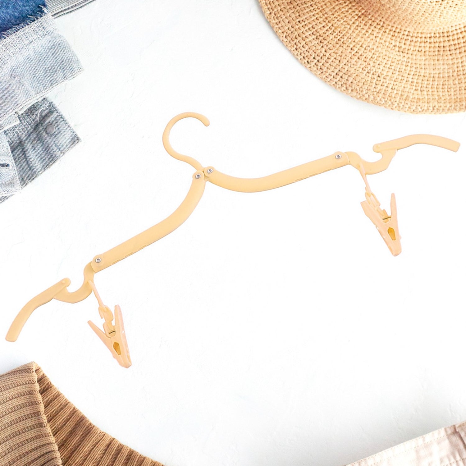 Adjustable folding clothes hanger with clips for versatile garment hanging