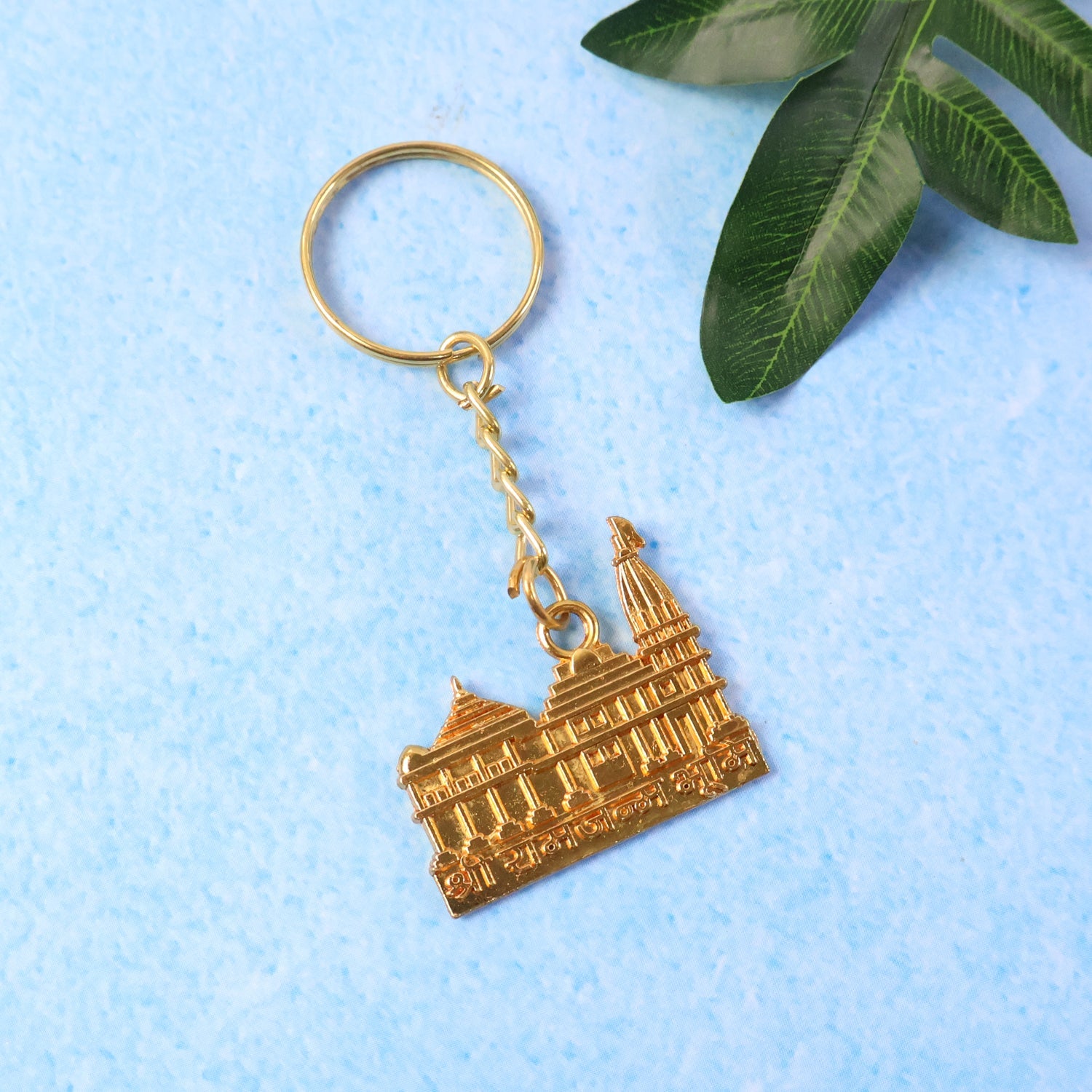 Premium golden metal Ram Mandir keychain showing detailed temple design
