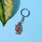 Side view of Radha Krishna metal keychain highlighting thickness and design