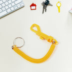 Detail of the coiled keychain's strong carabiner clip and metal key ring