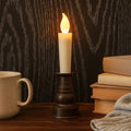 Premium LED flameless candle with holder showing warm flickering light