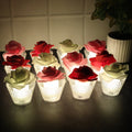 Set of Rose Shaped Flameless LED Candles glowing softly with glass holders