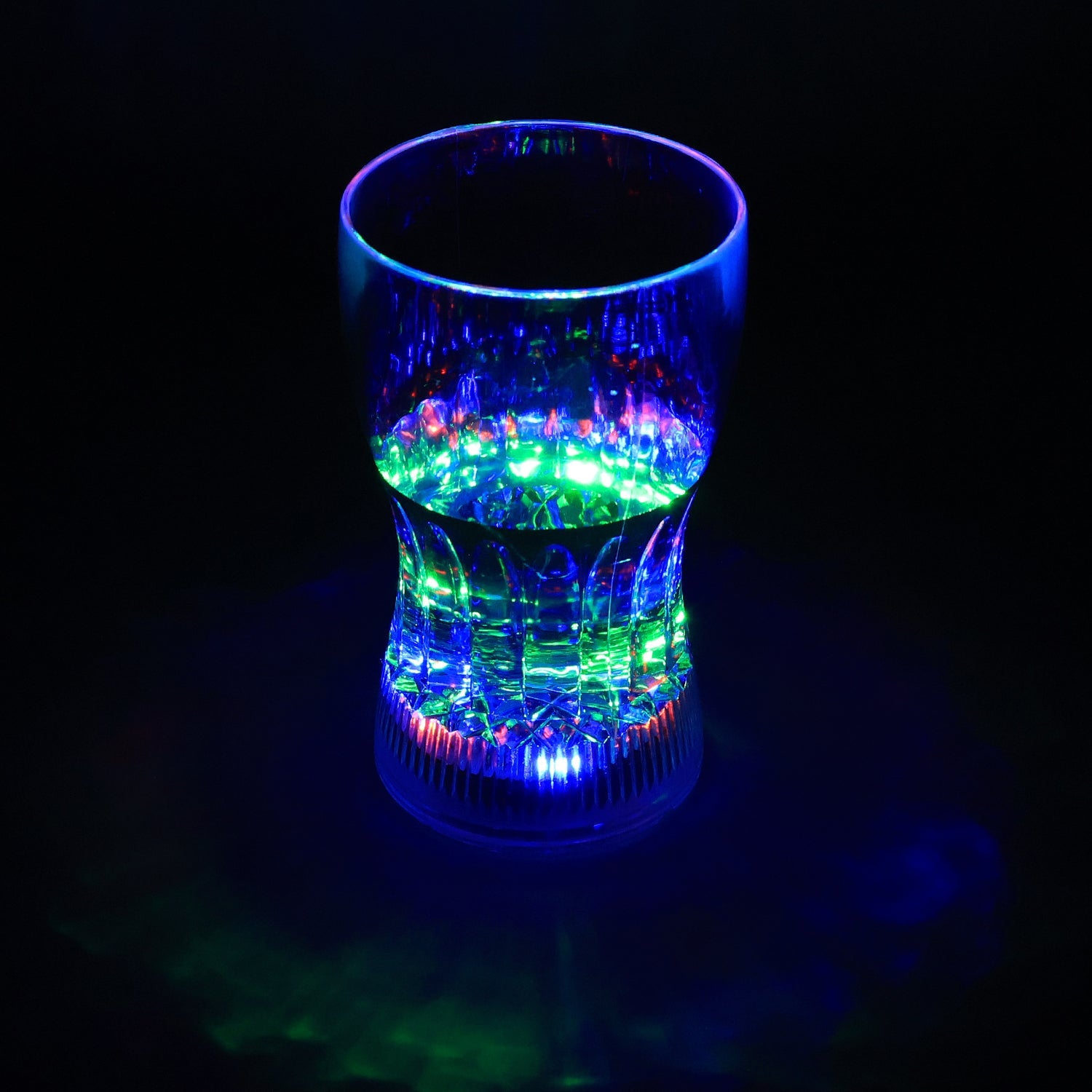 LED Light Glass illuminating a beverage with vibrant colors in a dark setting.