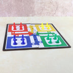 Pocket Ludo game board set up for play with colourful pawns and dice.