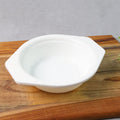 Plastic serving and mixing bowl with easy-grip side tabs on white background