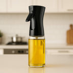Glass oil spray bottle with ergonomic trigger for cooking.