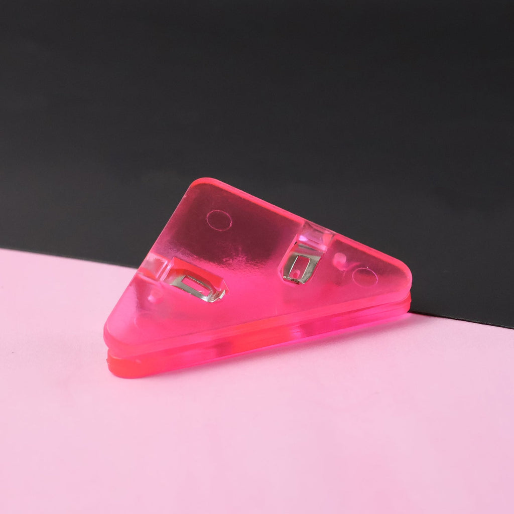 Triangle paper clip protecting paper corner from damage