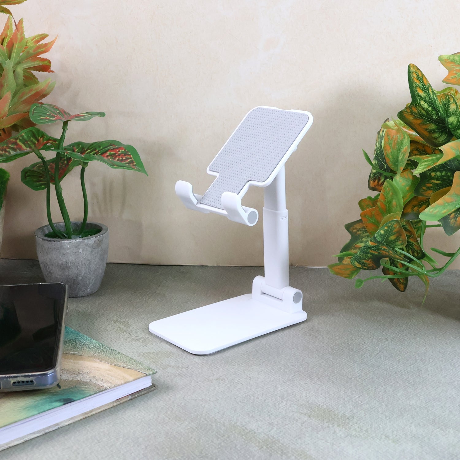 Foldable adjustable desktop mobile stand holding a smartphone securely