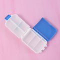 Blue dual-sided pill organizer box showing compartments