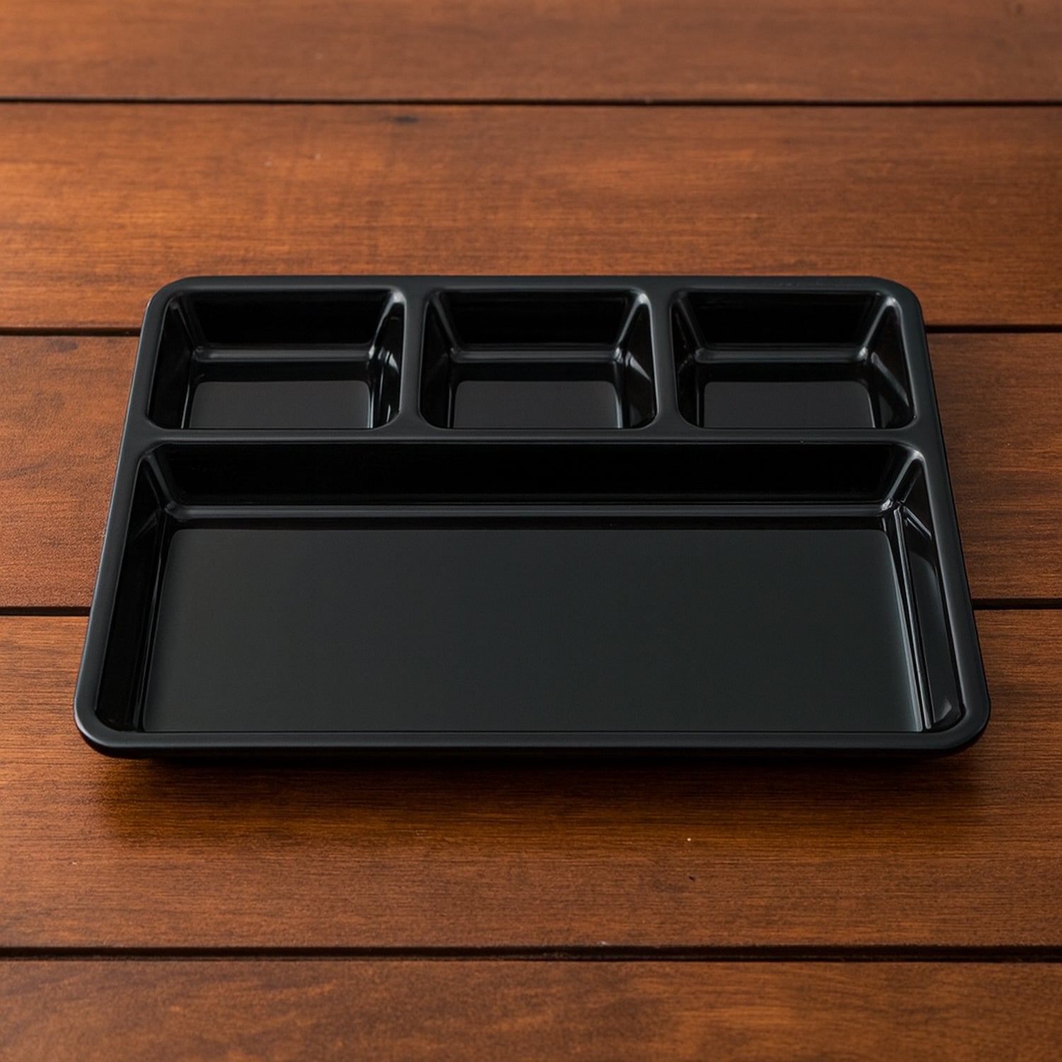 Rectangular plastic 4-compartment meal tray with four sections for neat plating.