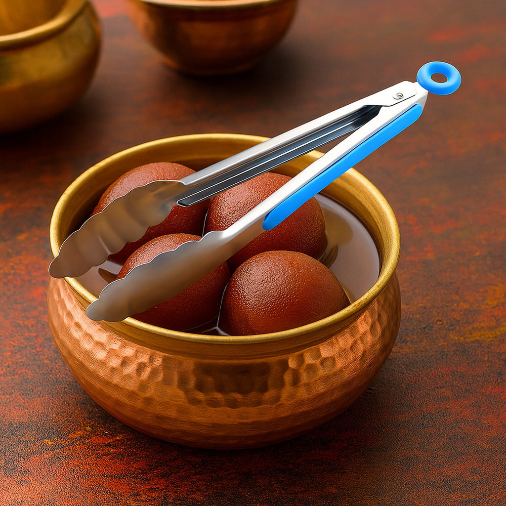 Stainless steel chef serving tong with silicone grip on kitchen counter