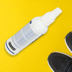 Shoe Deodorizer Spray bottle with clean socks and white sneakers.