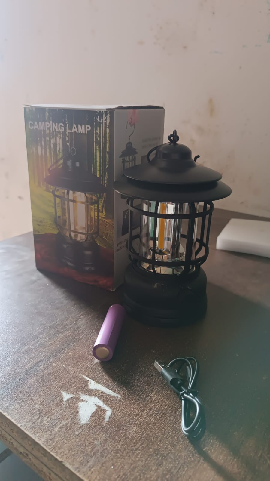Elegant retro style rechargeable LED camping lantern displayed on a wooden table.