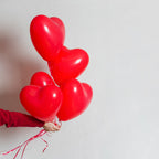 Lively party setting adorned with multiple heart shaped balloons.