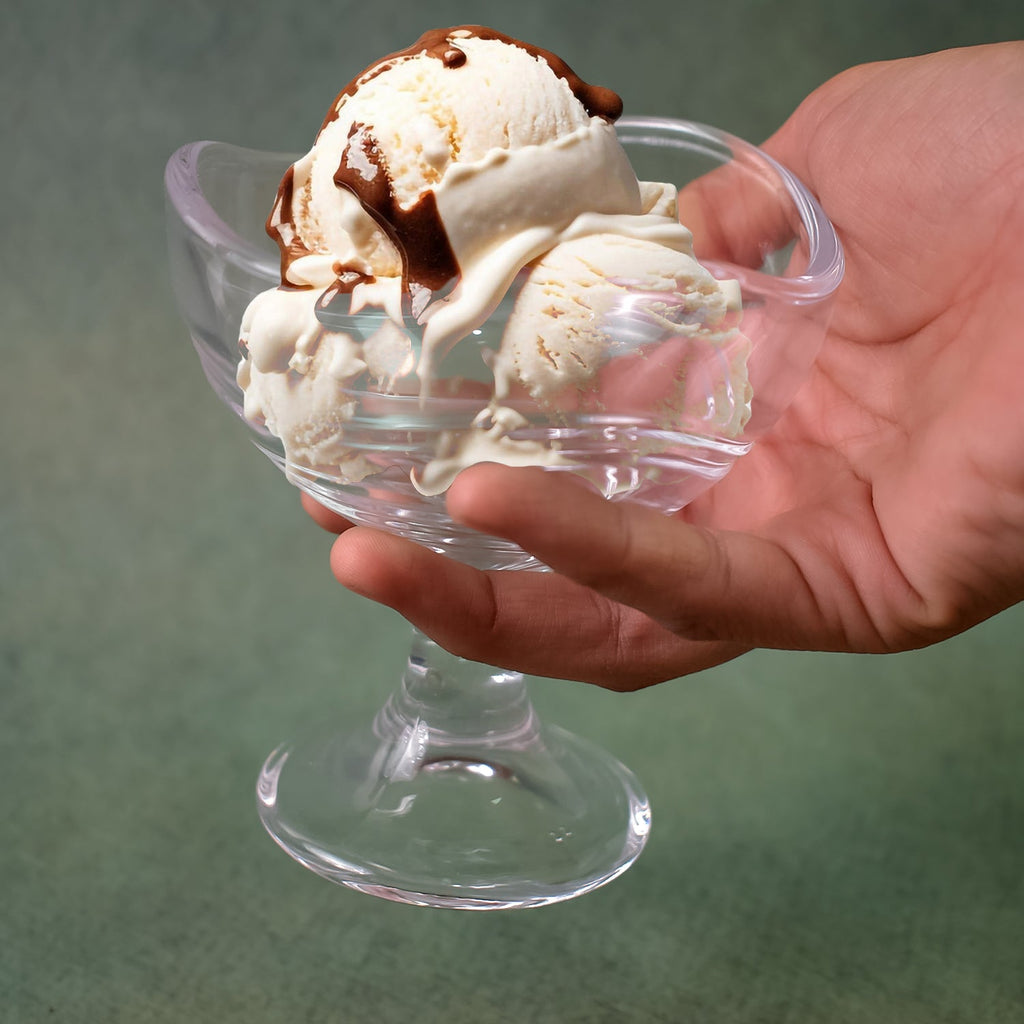 Close-up of a stylish footed glass dessert bowl from the set.