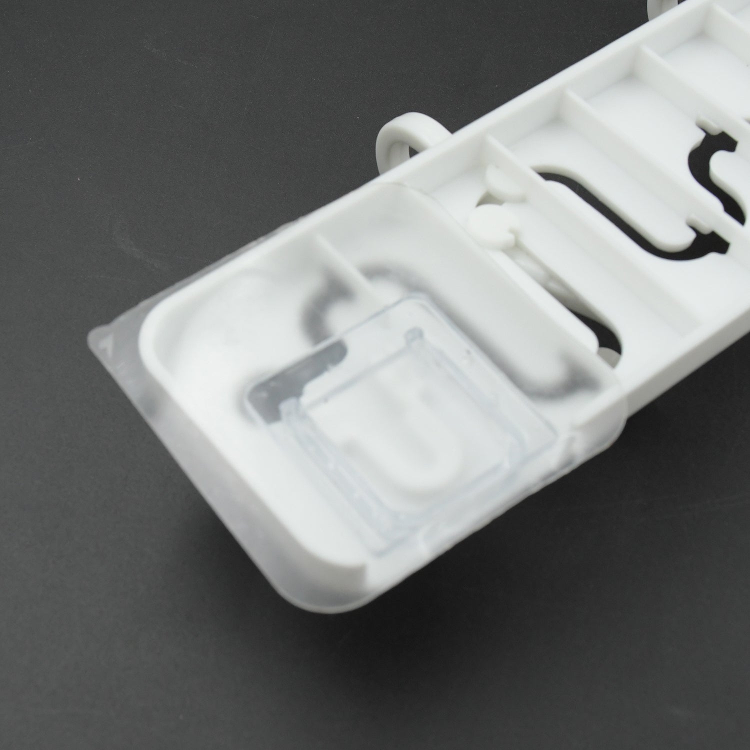 Pack of adjustable wall hooks ready for home installation.