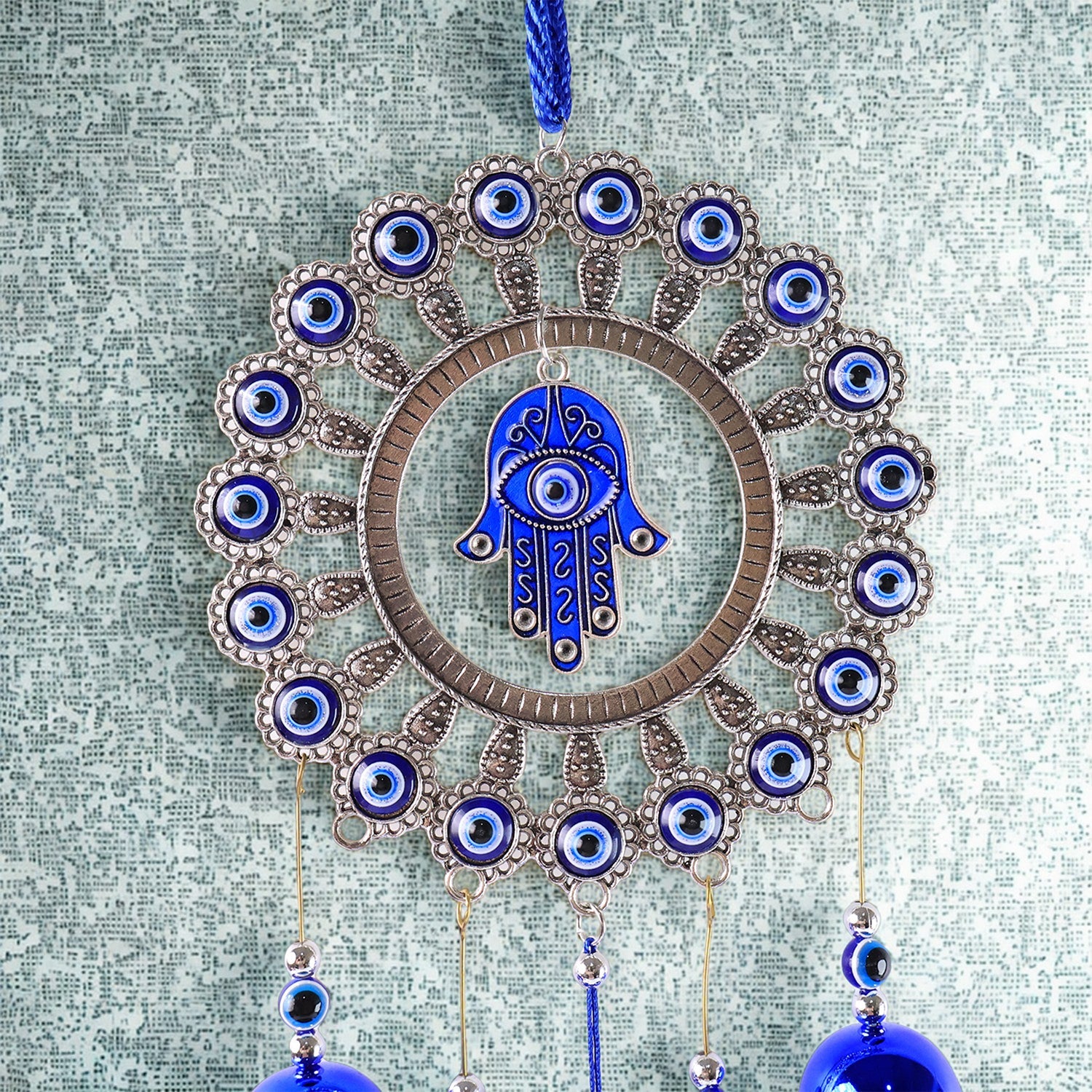 Close-up of detailed alloy and glass beadwork on Om Evil Eye chime