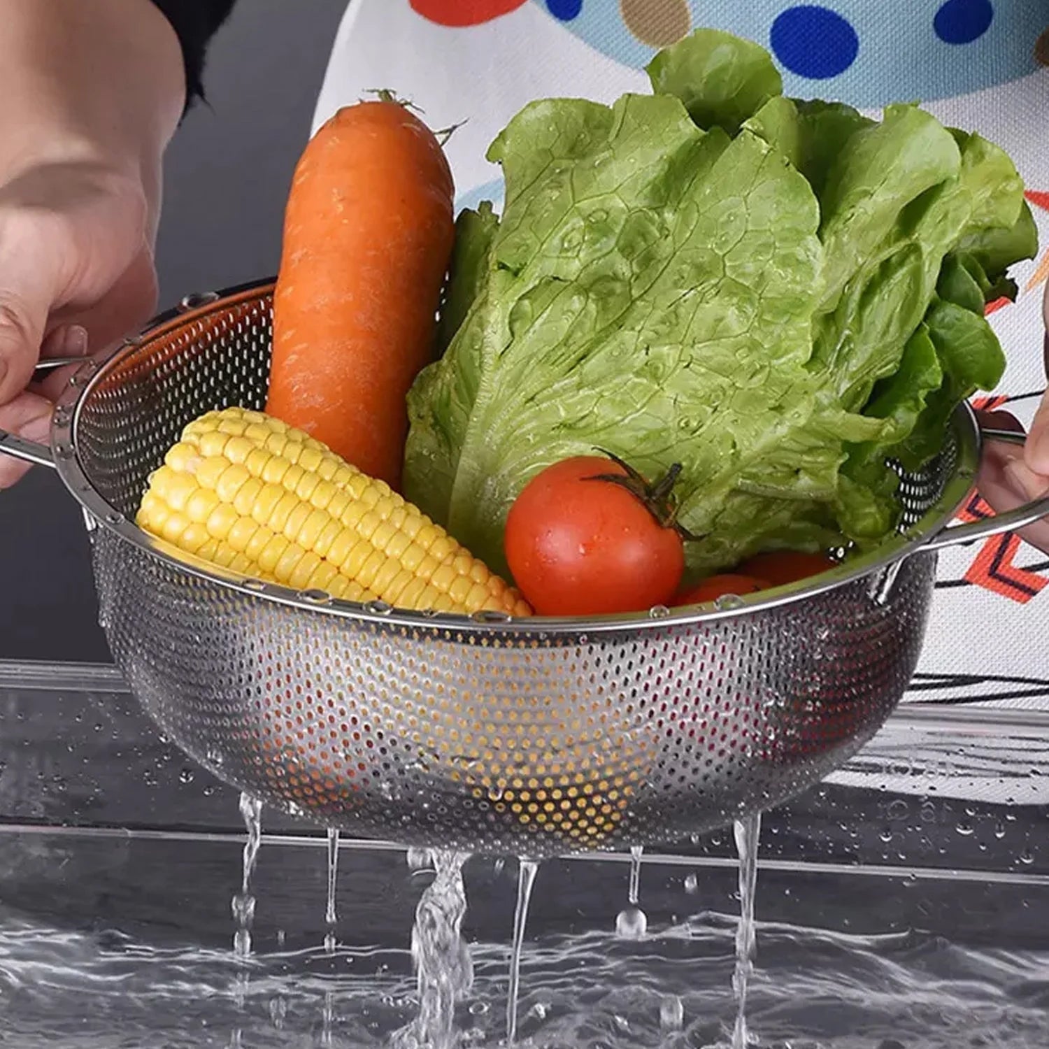 Stainless steel colander with ergonomic handle, viewed from above, showcasing fine mesh.