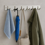 Stainless steel coat rack with 6 hooks mounted on the wall for hanging
