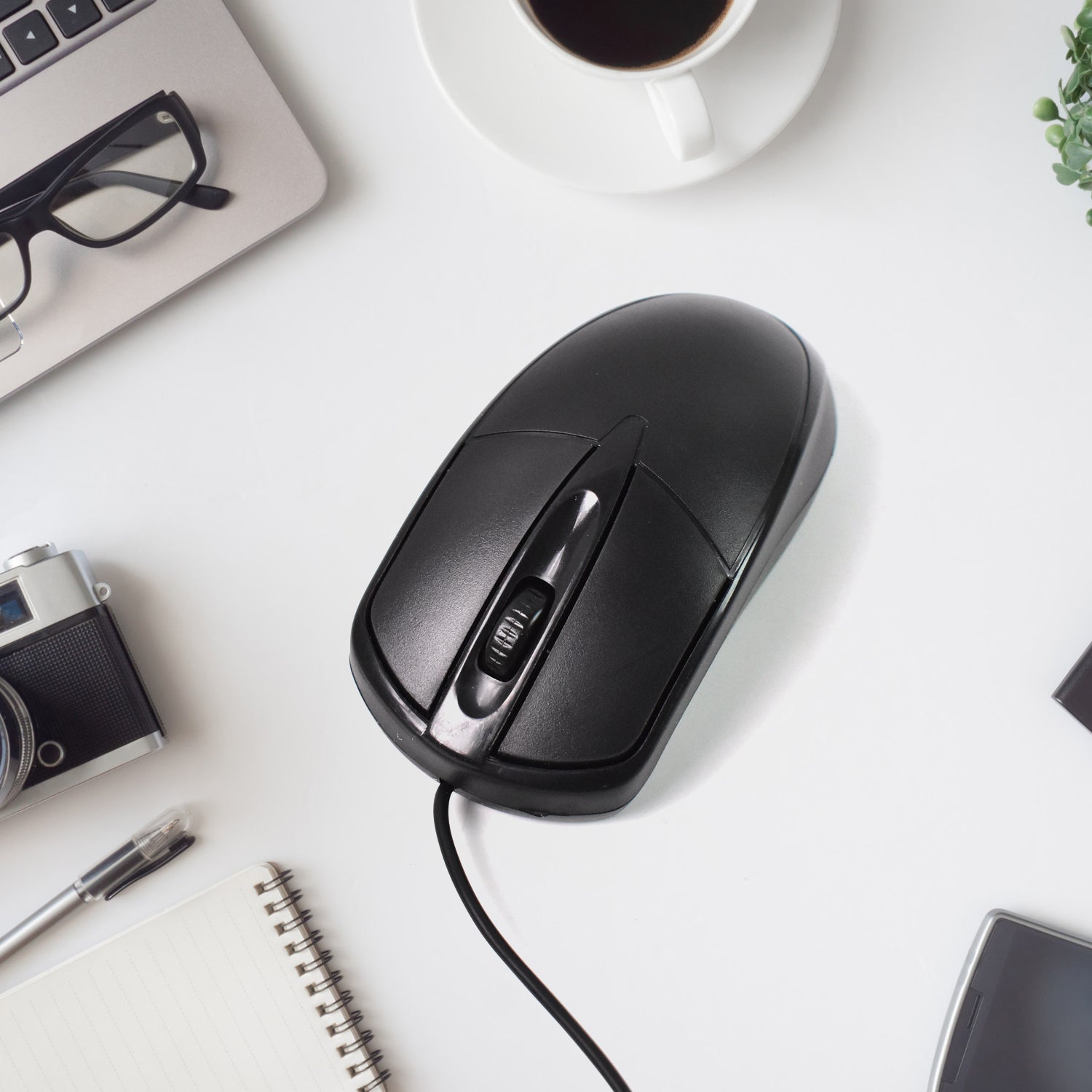 Top-down view of the black wired optical mouse, showcasing its simple and functional layout.
