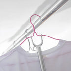 Collapsible garment hanging stick demonstrating its compact storage feature.