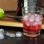 Refreshing drink in a glass with several perfectly round silicone ice cubes.