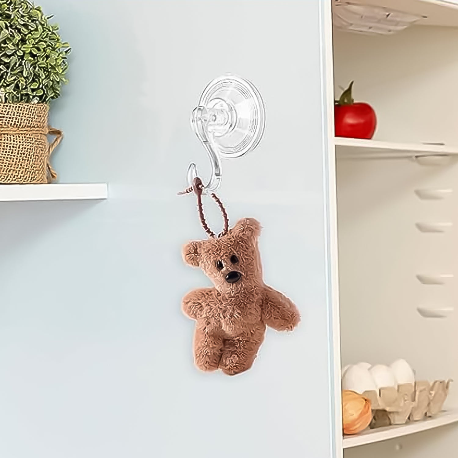 Plastic suction cup hooks in use on bathroom tiles holding items