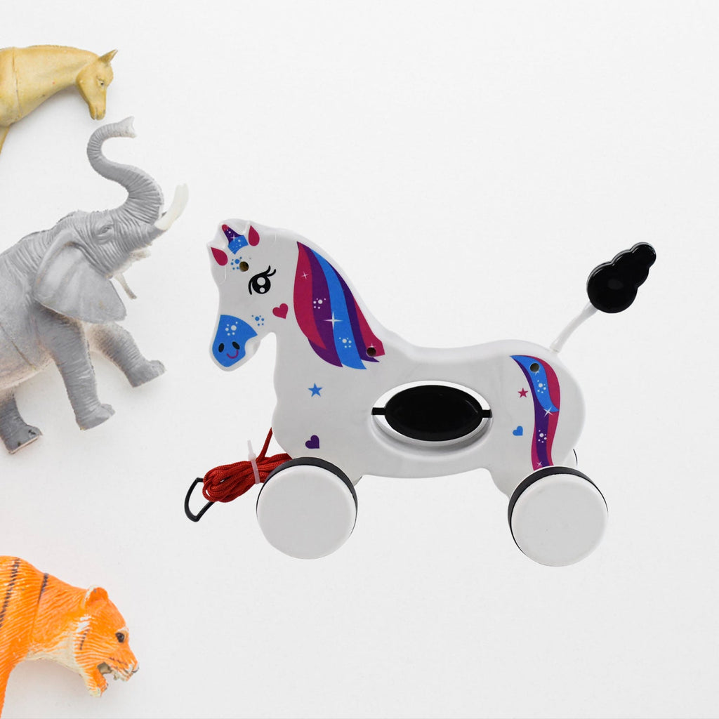 Toddler happily playing with the Unicorn pull along toy encouraging walking