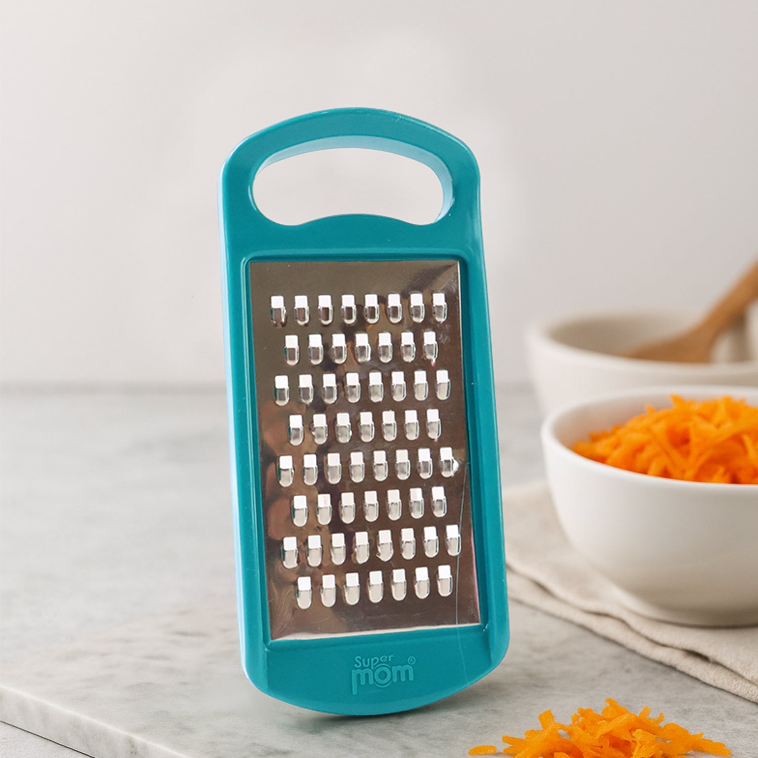Side angle showing sharp stainless steel blade of Supermom multipurpose grater