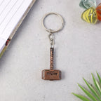 Side perspective of metal hammer keychain showing thickness
