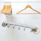 Kitchen towel hanger mounted on a wall, showcasing its versatility for kitchen use.