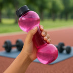 User holding the FitFuzion dumbbell water bottle during a light workout session.