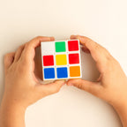 A vibrant 3x3 Rubik's Cube displayed prominently against a clean white background, showcasing its classic design.