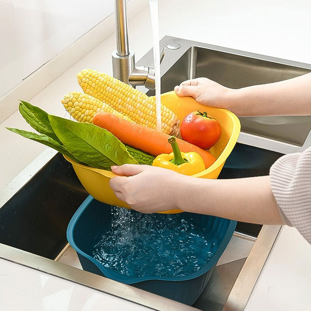 Plastic washing bowl with integrated strainer, perfect for kitchen use.