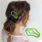 Single multicolor metal hair clip on a neutral surface