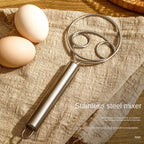 Professional-grade dough whisk displayed on a kitchen countertop.