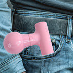 Hand holding the black mini massager, demonstrating ease of use.