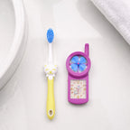 Kids cartoon toothbrush with fan toy held in hand