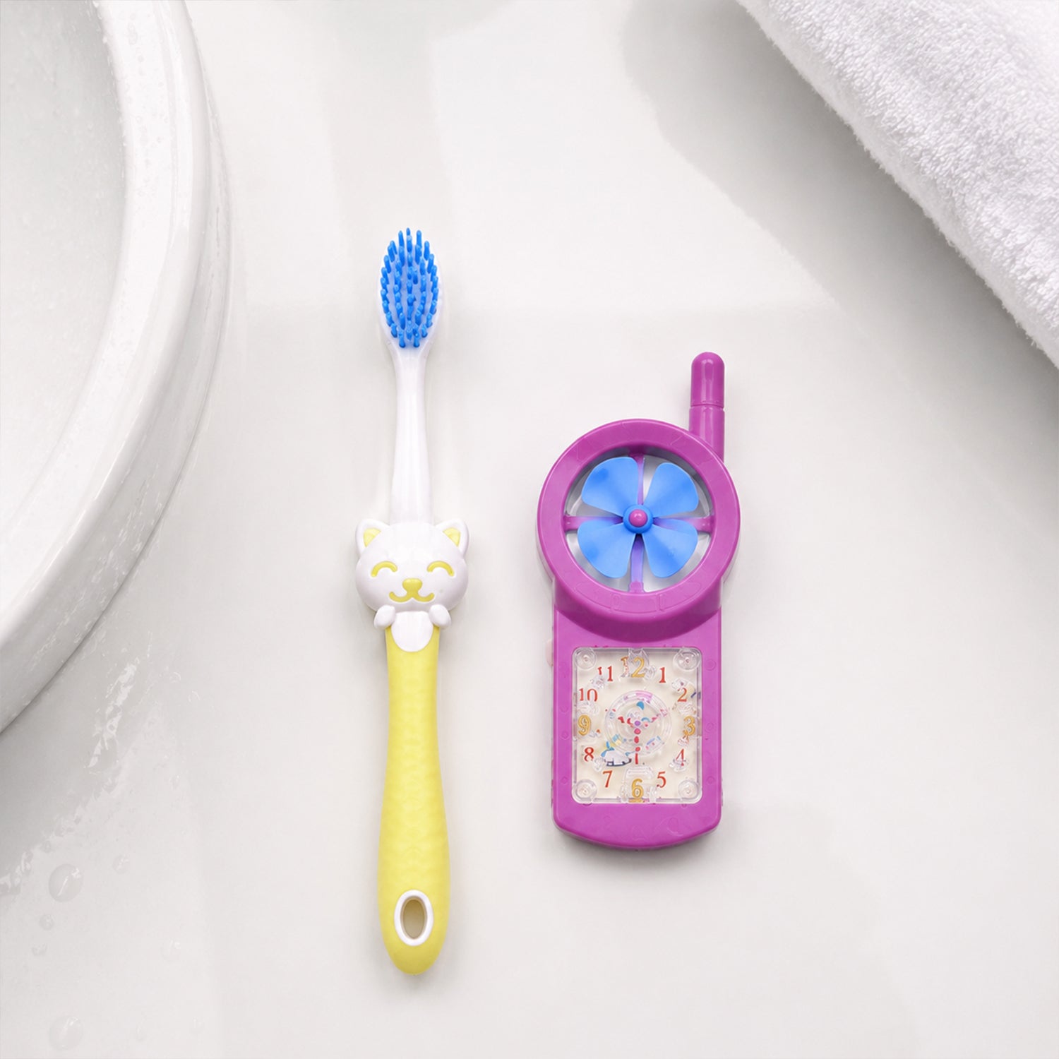 Kids cartoon toothbrush with fan toy held in hand