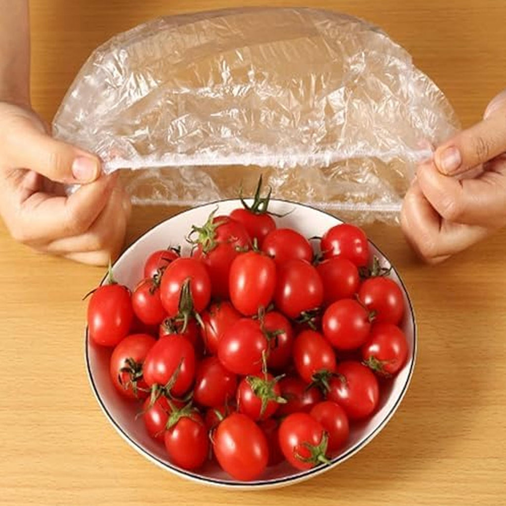 An elastic food cover keeping a plate of sliced fresh fruits perfectly sealed.