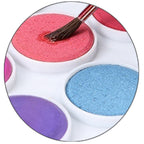 Detailed shot of the 13-piece watercolor kit, showing 12 vibrant colors and the quality paint brush.