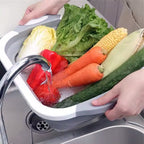 The collapsible cutting board with integrated drain plug for easy water release.