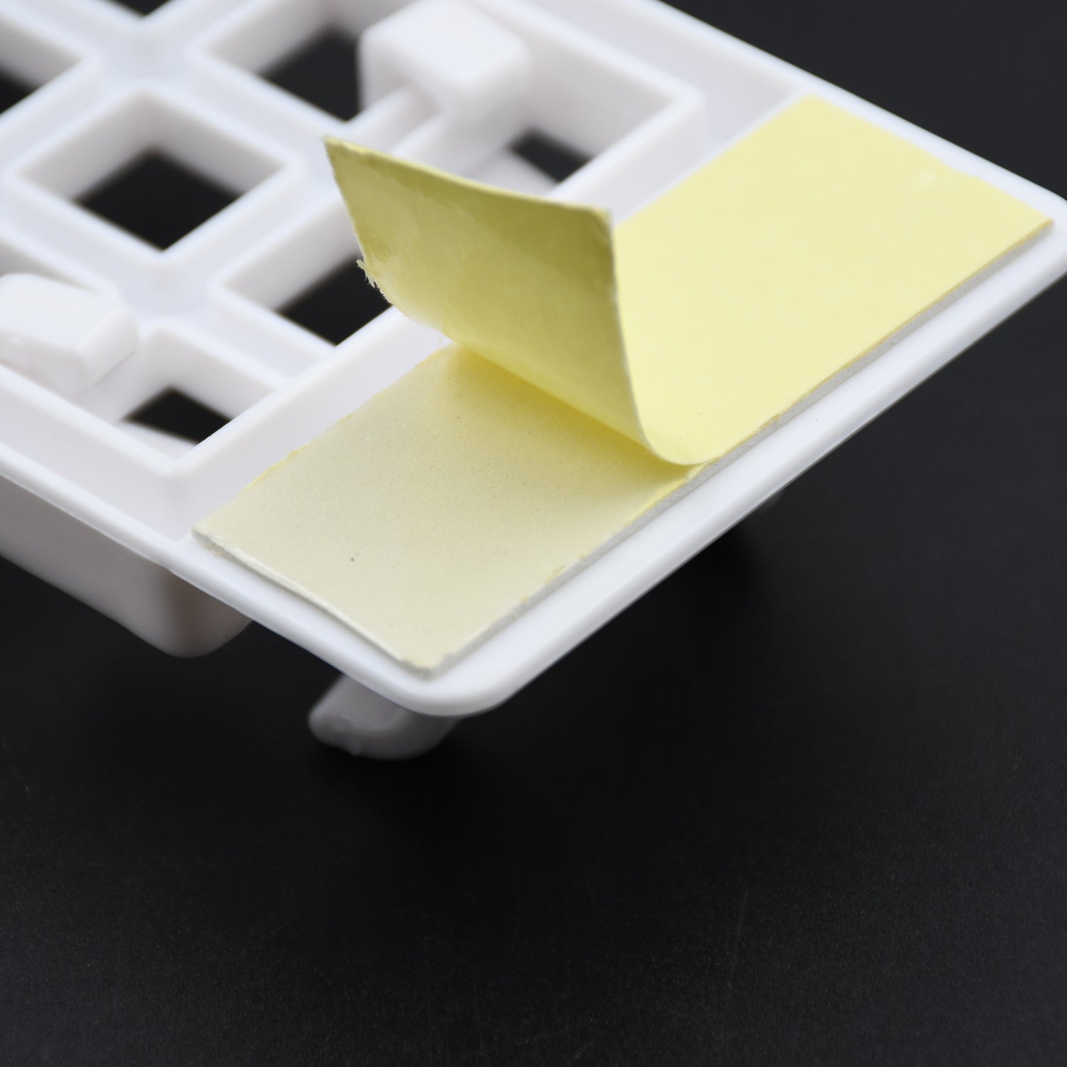 Lifestyle image of the durable plastic wall hook in a kitchen, holding utensils.