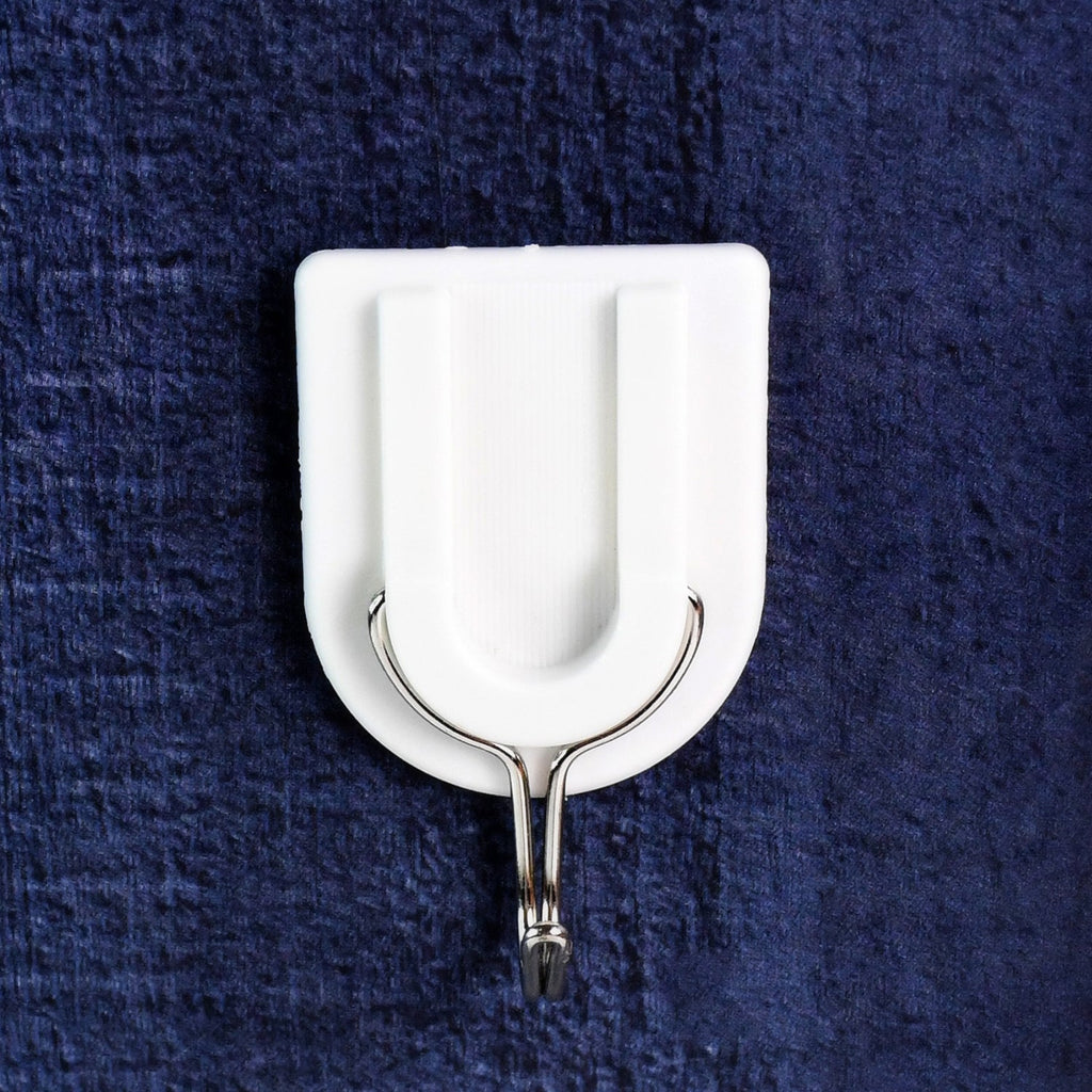 A small adhesive hook in a hallway, perfect for hanging keys and other small items.