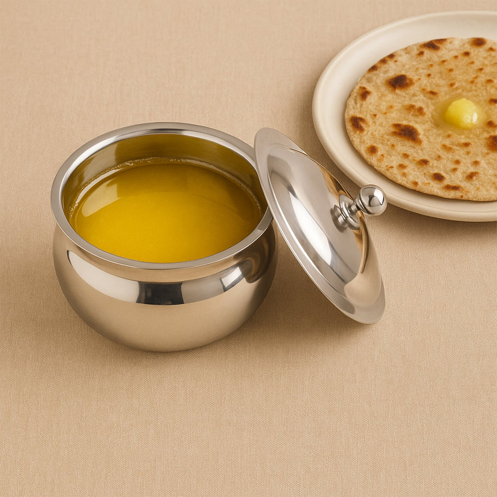 Detailed shot of the Stainless Steel Ghee Pot and its matching serving spoon.