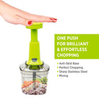 Manual vegetable chopper with a clear bowl, filled with freshly and finely chopped vegetables.