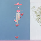 Decorative details of butterfly and dragonfly on colorful wind chime