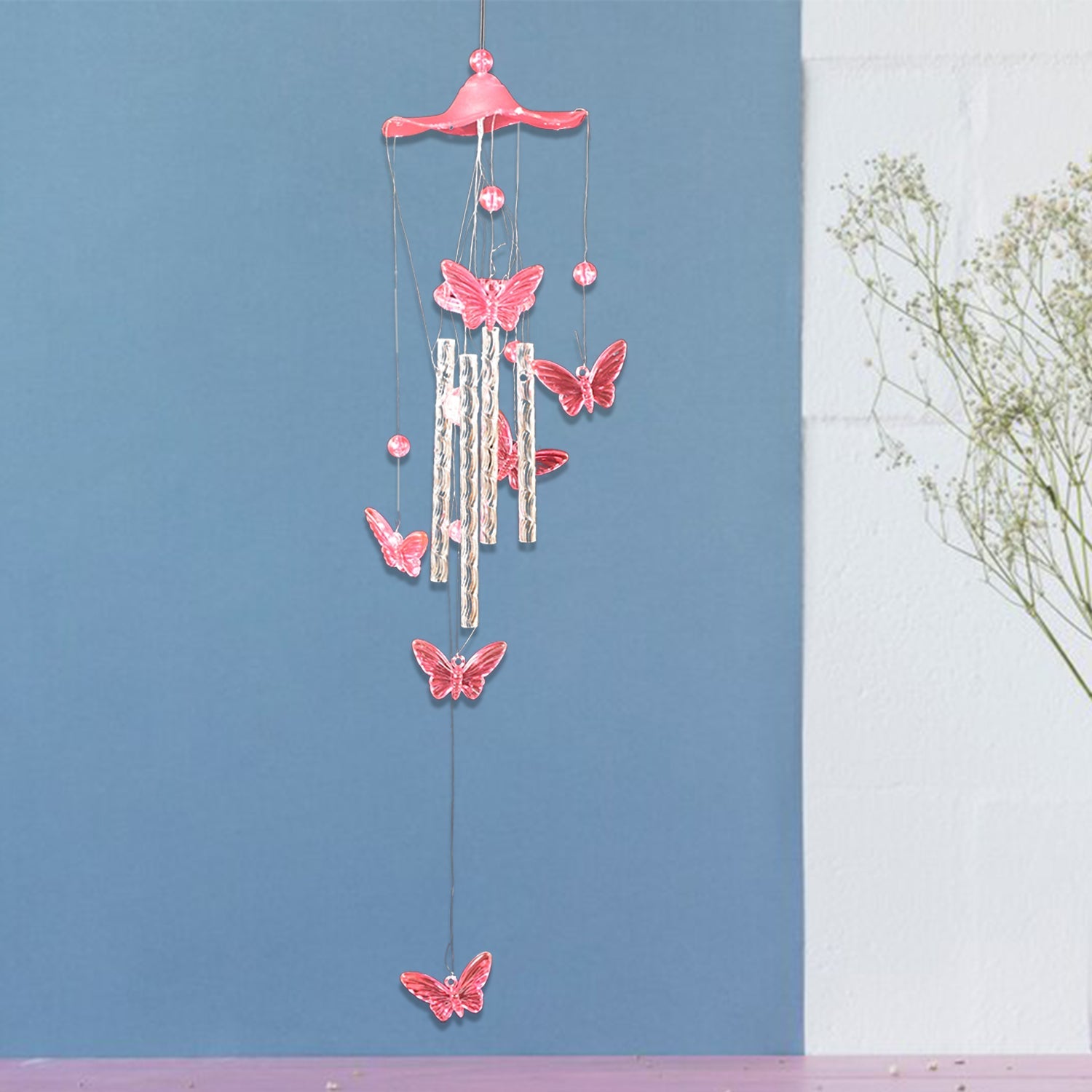 Decorative details of butterfly and dragonfly on colorful wind chime